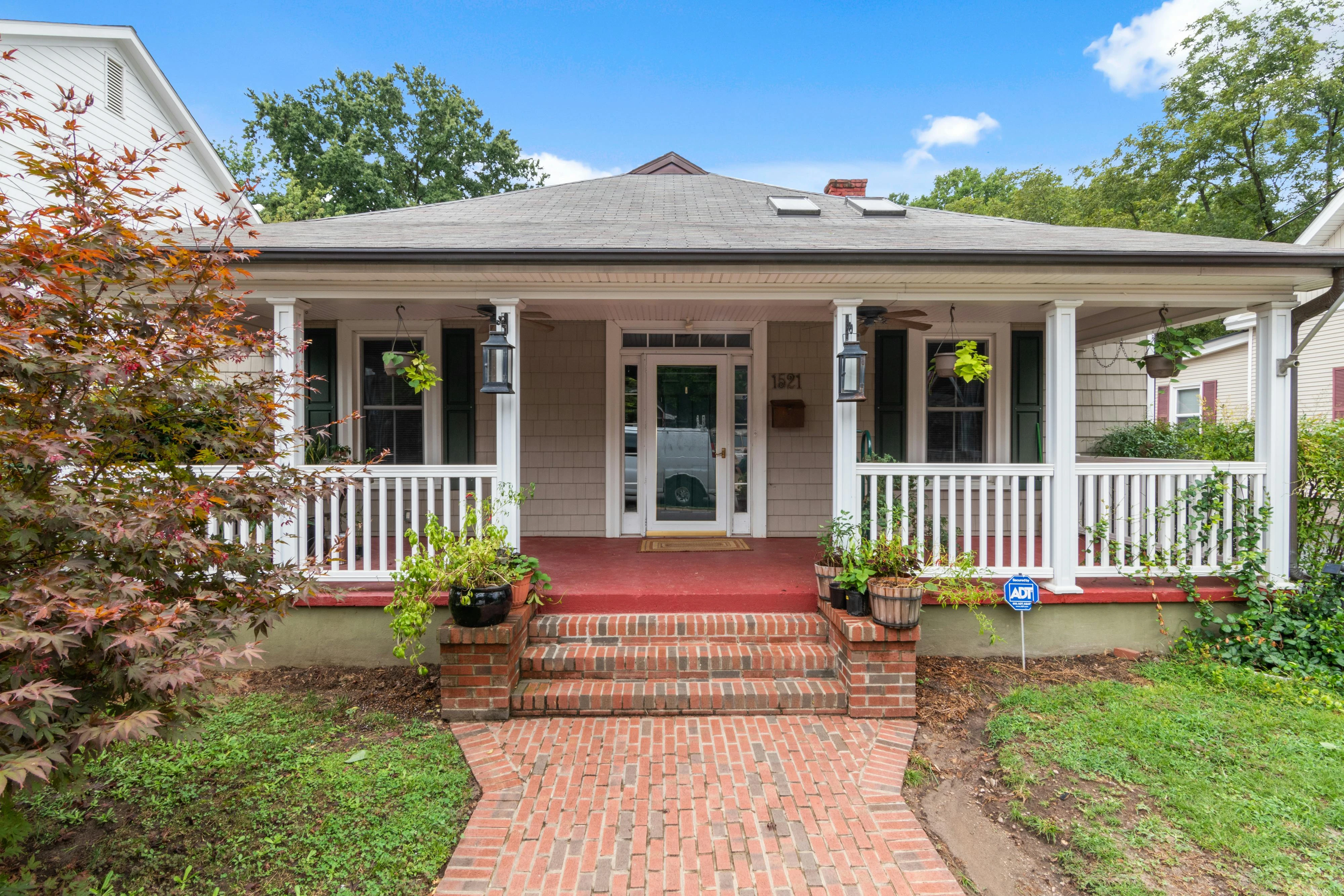 A beautifully designed front yard with a welcoming walkway and layered plantings.