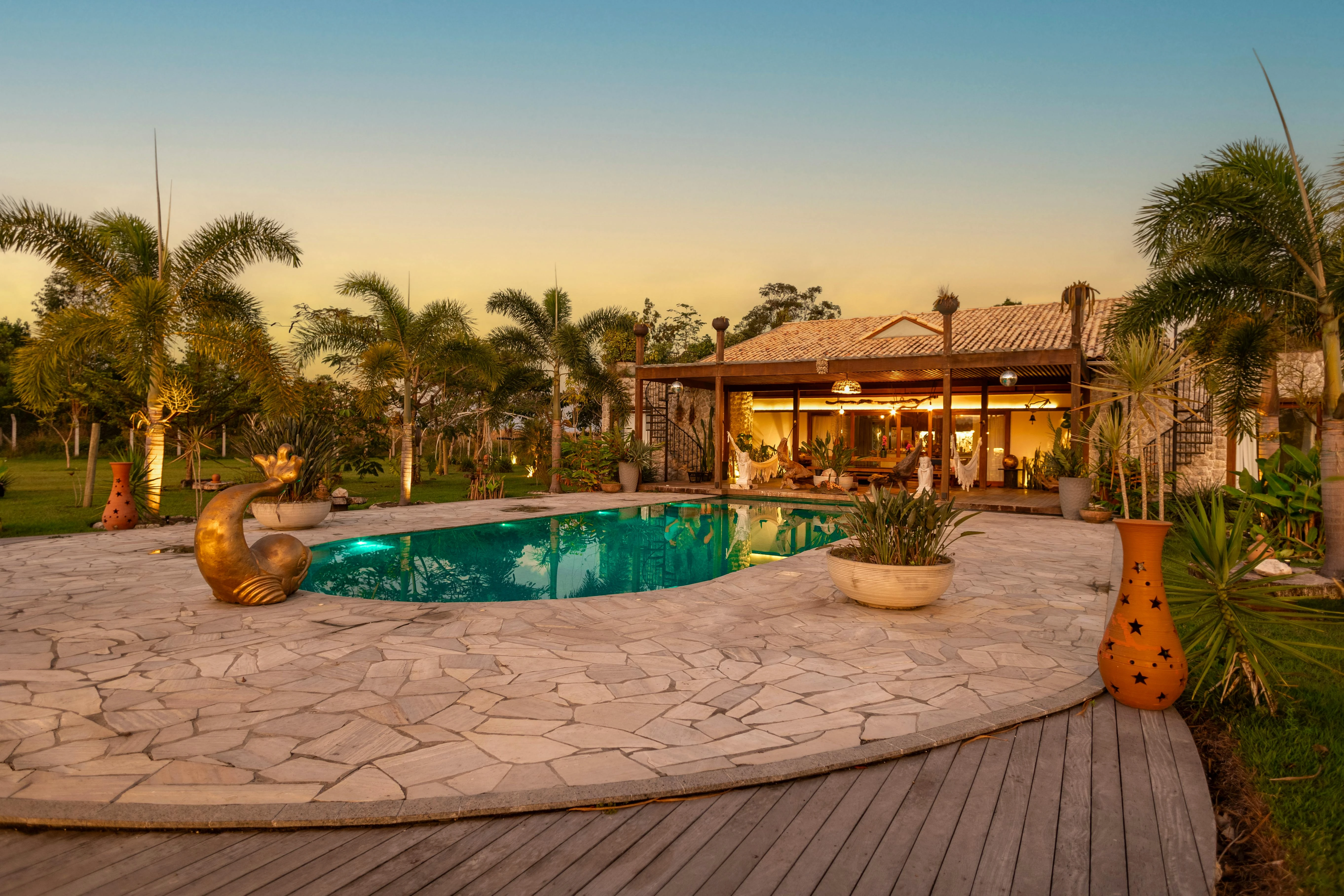 Elegant landscaping around a swimming pool, with ornamental grasses and stone decking.